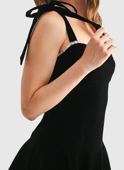 Black strappy mini dress with flared skirt and lace trim